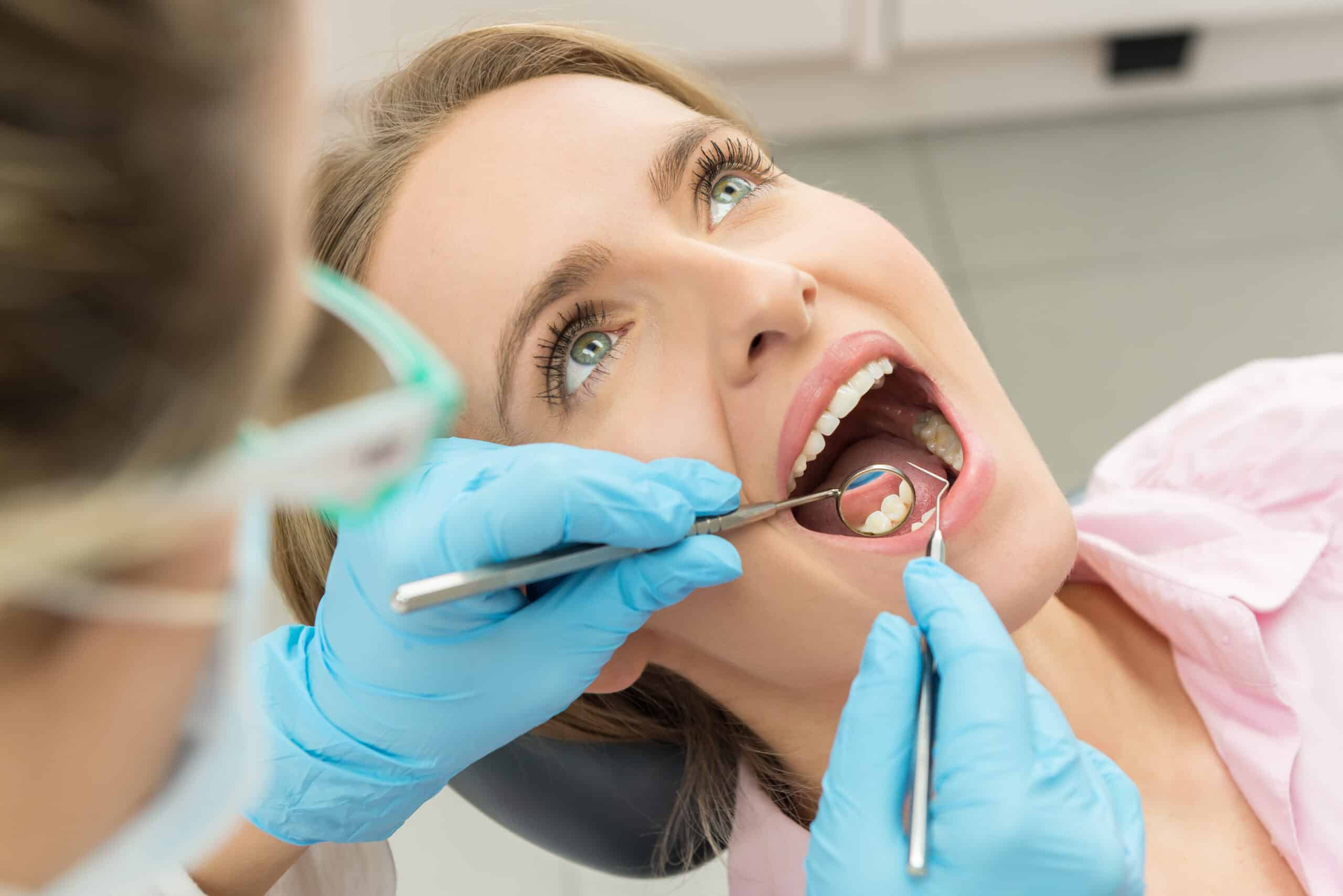 Woman having her teeth examined for dental crowns