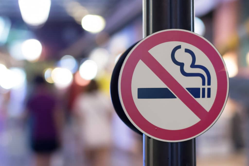 A no smoking sign with a blurred background. 