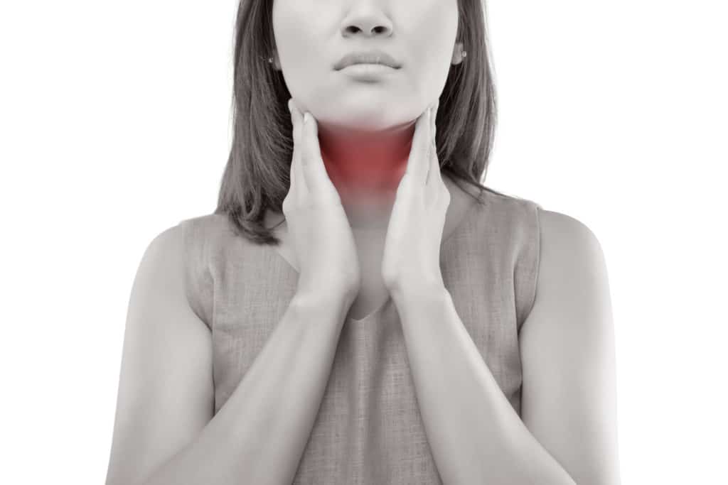 A women's thyroid gland highlighted red. Her thyroid glad is sore and causing her pain.