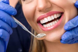 A dentist examining a patient's teeth before BIOLASE laser treatments