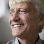 A senior man with dentures smiling