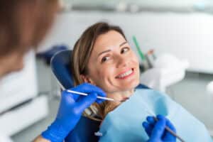 A woman sitting in a dentist's chair during a laser dentistry appointment